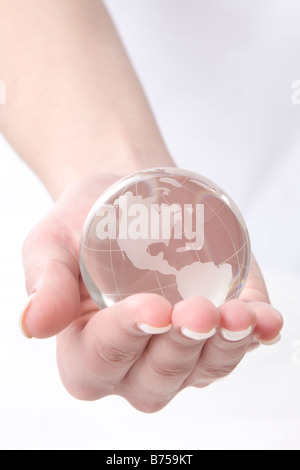 Female hand holding a globe, Winnipeg, Manitoba Stock Photo