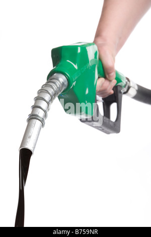 Hand holding gas nozzle with stream of oil flowing out Stock Photo