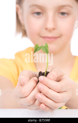9 year old girl with the small plant in her hands, Winnipeg, Manitoba