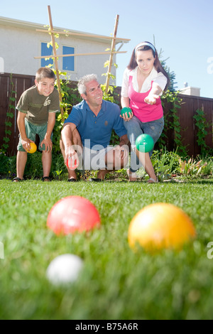 Family playing bocce ball in backyard, Winnipeg, Manitoba, Canada Stock Photo