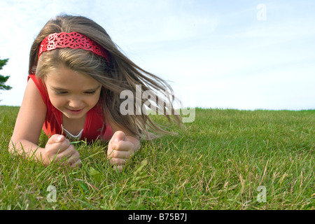 Six year old girl on grass, Winnipeg, Manitoba, Canada Stock Photo