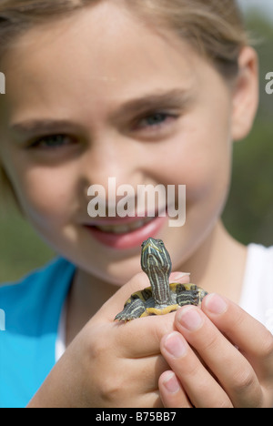 Turtle held by eight year old girl, Winnipeg, Canada Stock Photo