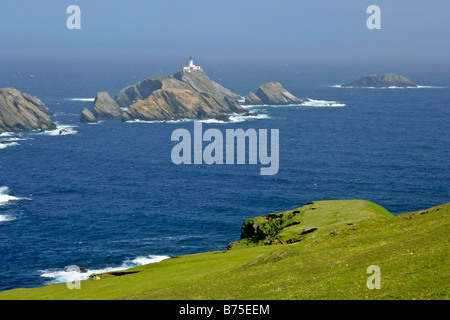 Muckle Flugga lighthouse most northerly lighthouse of Great Britain situated on offshore cliff seen from Hermaness Nature Reserv Stock Photo