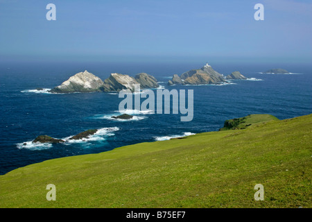 Muckle Flugga lighthouse most northerly lighthouse of Great Britain situated on offshore cliff seen from Hermaness NatureReserve Stock Photo