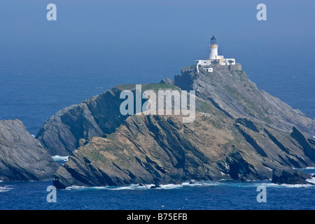 Muckle Flugga lighthouse most northerly lighthouse of Great Britain situated on offshore cliff seen from Hermaness NatureReserve Stock Photo