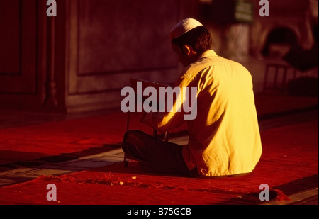 Muslim man praying in Jama Masjid in the old town of Delhi, India Stock Photo