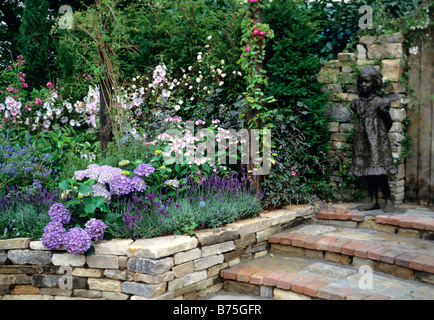 Hydrangeas Lavatera Barnsley and Lavender Hidcote in a shady border Stock Photo