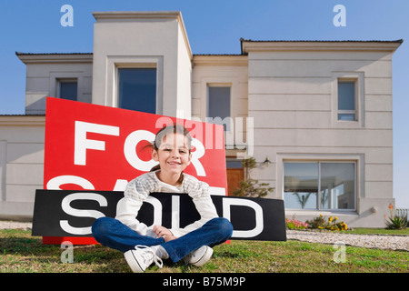 Portrait of a girl holding a sold information board and smiling Stock Photo