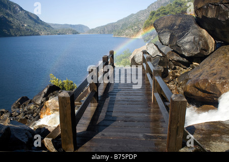 CALIFORNIA - Rainbow over the trail at the base of Wapama Falls along the banks of the Hetch Hetchy Reservoir in Yosemite. Stock Photo