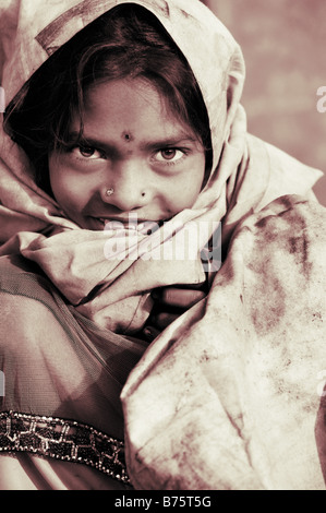 Poor nomadic indian girl wrapped in a dirty sheet. Portrait. Andhra Pradesh, India Stock Photo