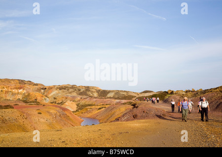 Amlwch Anglesey North Wales UK Group of walkers on Mynydd Parys Mountain open cast copper ore mine Stock Photo