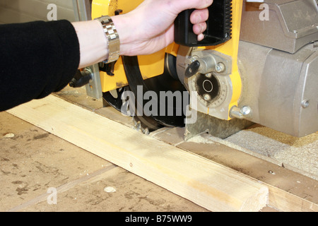 Man operating a large table saw Stock Photo