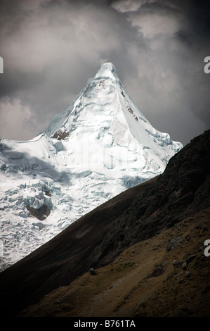 The perfect pyramidal shape of the Nevado Alpamayo, one of the most beautiful mountains in Peru's Cordillera Blanca. Stock Photo