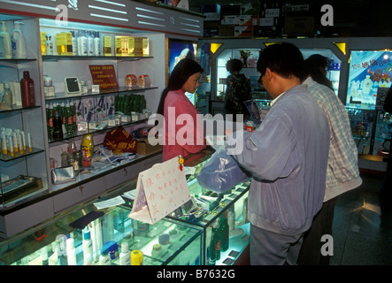 Chinese people, salesclerk, shoppers, shopping, cosmetic counter, department store, city of Kunming, Yunnan Province, China Stock Photo