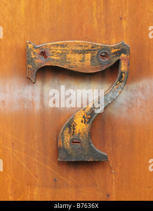 grungy number seven affixed to rusty industrial metal Stock Photo