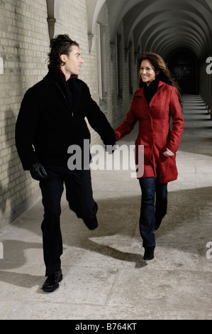 License available at MaximImages.com - Young couple running together in a city Stock Photo