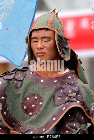 Mongolian horseman in traditional warrior outfit at the Gegentala Grassland tourist centre, Inner Mongolia, northern China Stock Photo
