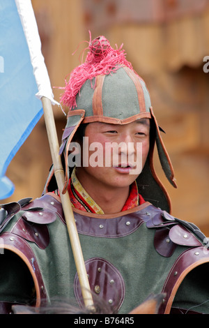 Mongolian horseman in traditional warrior outfit at the Gegentala Grassland tourist centre, Inner Mongolia, northern China Stock Photo
