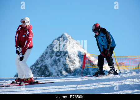 a young boy getting skiing lessons at mountain station Gamsgarten at Stubai Glacier in Tyrol, Austria Stock Photo