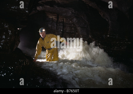 A caver in the streamway, Ogof Ffynnon Ddu, Brecon Beacons, Wales Stock Photo