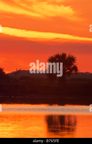 red sunset lake black point wildlife drive merritt island florida usa america backlight reflection Stock Photo