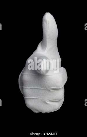 Hand in a white glove with the finger pointing towards YOU isolated on a black background Stock Photo