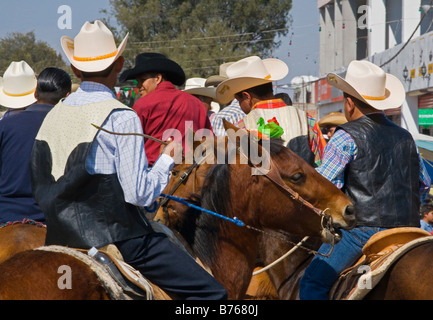 CABALLEROS or Mexican cowboys ride into town at the festival of the VIRGIN OF GUADALUPE LOS RODRIGUEZ GUANAJUATO MEXICO Stock Photo