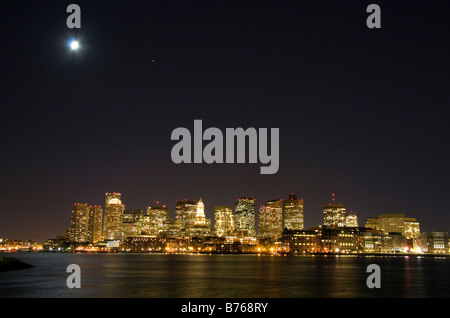 Boston skyline on a moonlight starry night with Boston Harbor in the foreground Massachusetts USA Stock Photo