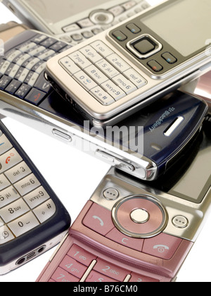 Collection or Pile of Old Yesterdays Technology Mobile Cell Phones Out Of Date No longer Used Or Wanted As Communication Technology Advances Stock Photo