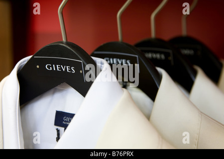 Gieves & Hawkes men's tailors displaying suits on hangers in their flagship store in Savile Row London United Kingdom. Stock Photo