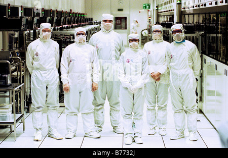 Group of workers in the clean environment of a semi conductor silicon wafer foundry South Wales UK