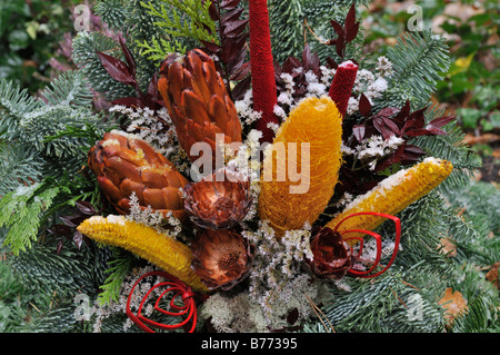 Grave decoration with dried flowers and dyed plant parts Stock Photo