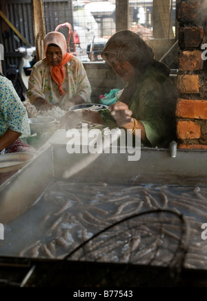 Traditional fish sausage maker in Terengganu Malaysia Fish sausage normally can be consumed after boiling them or deep fried. Stock Photo