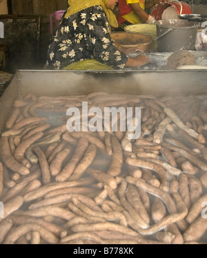 Traditional fish sausage maker in Terengganu Malaysia. Fish sausage normally can be consumed after boiling them or deep frying. Stock Photo