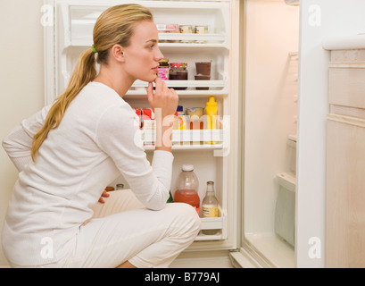 Woman looking inside refrigerator Stock Photo
