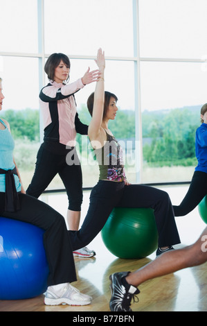 Instructor guiding fitness class Stock Photo
