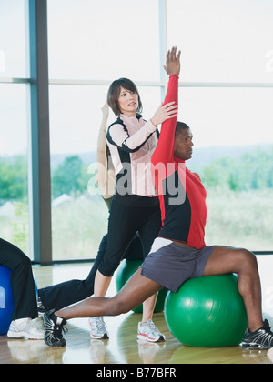 Instructor guiding fitness class Stock Photo