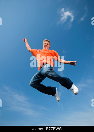 Portrait of teenage boy mid-air Stock Photo