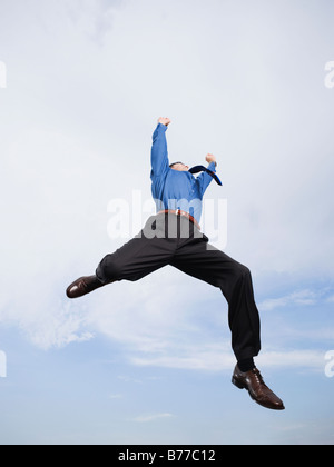 Businessman jumping mid-air Stock Photo
