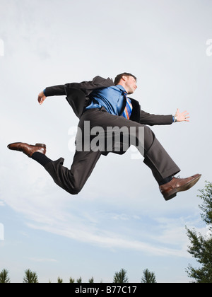 Businessman jumping mid-air Stock Photo