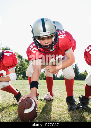 Football center preparing to snap football Stock Photo