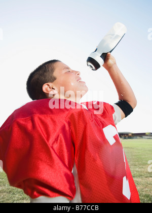 Football player spraying water on face Stock Photo