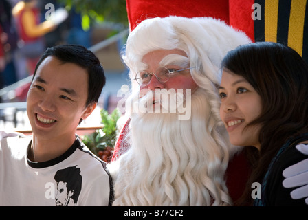 Father Christmas with couple, Hong Kong Disneyland Resort, Lantau Island, Hong Kong, People's Republic of China Stock Photo