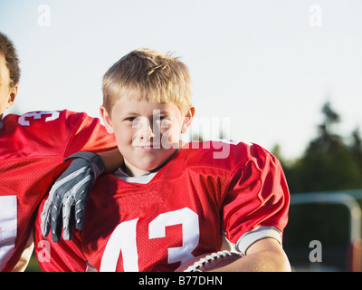 Football player posing on field Stock Photo