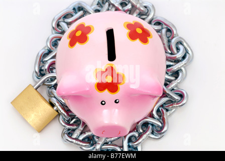Chain and padlock around piggybank Stock Photo