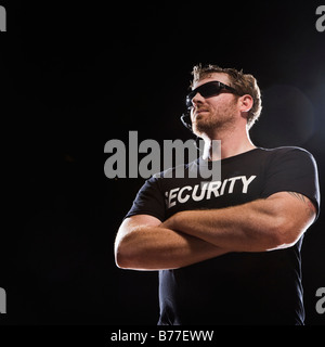 Security guard standing arms crossed Stock Photo