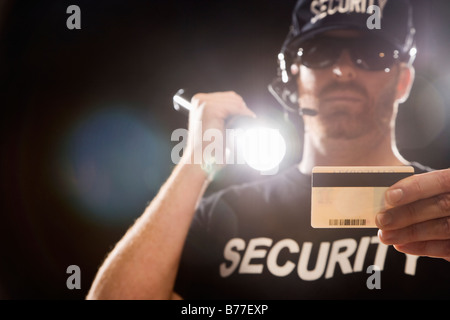 Bouncer checking identification flashlight Stock Photo