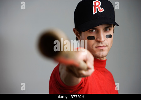 Close up of baseball player pointing bat Stock Photo