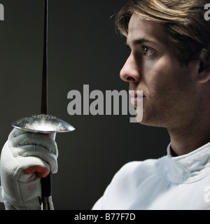 Close up of man holding fencing foil Stock Photo