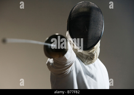 Close up of fencer mask pointing fencing foil Stock Photo